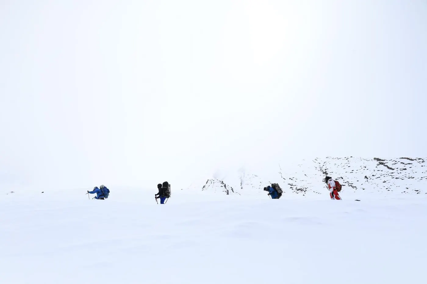 Team skinning across high-altitude snowfield